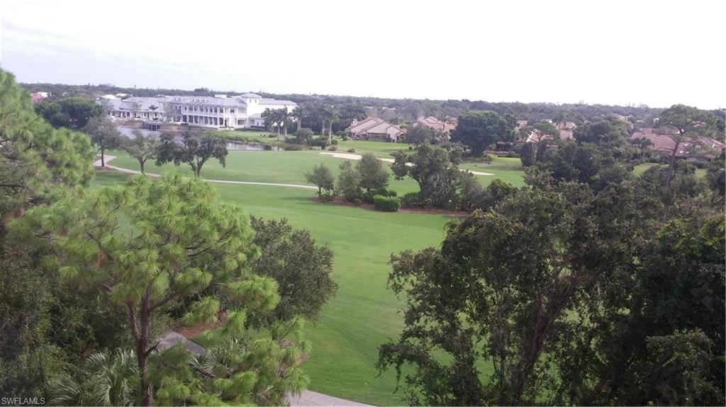 Aerial view of property and surrounding area with nearby suburban area, a local golf course, and a large body of water