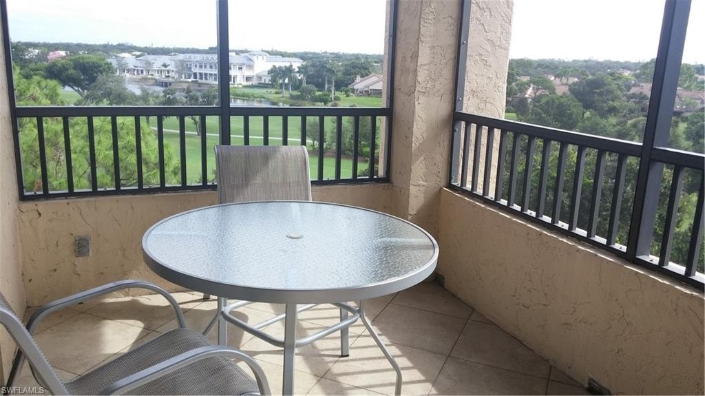 Balcony featuring a sunroom and a water view