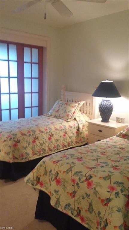 Bedroom featuring ceiling fan and carpet floors