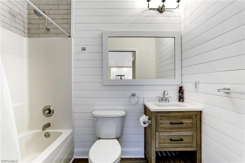 Downstairs full bath with shiplap walls and custom tile.