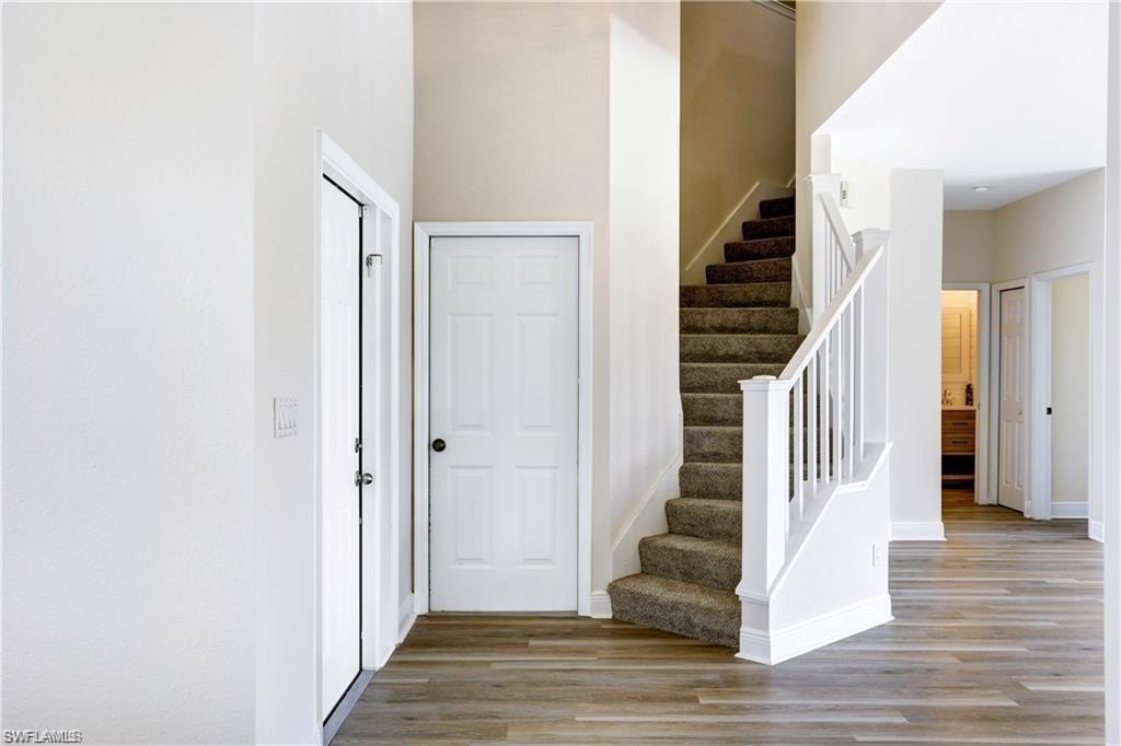 Entry door and other door leading out to the garage. Brand new carpet on stairs.