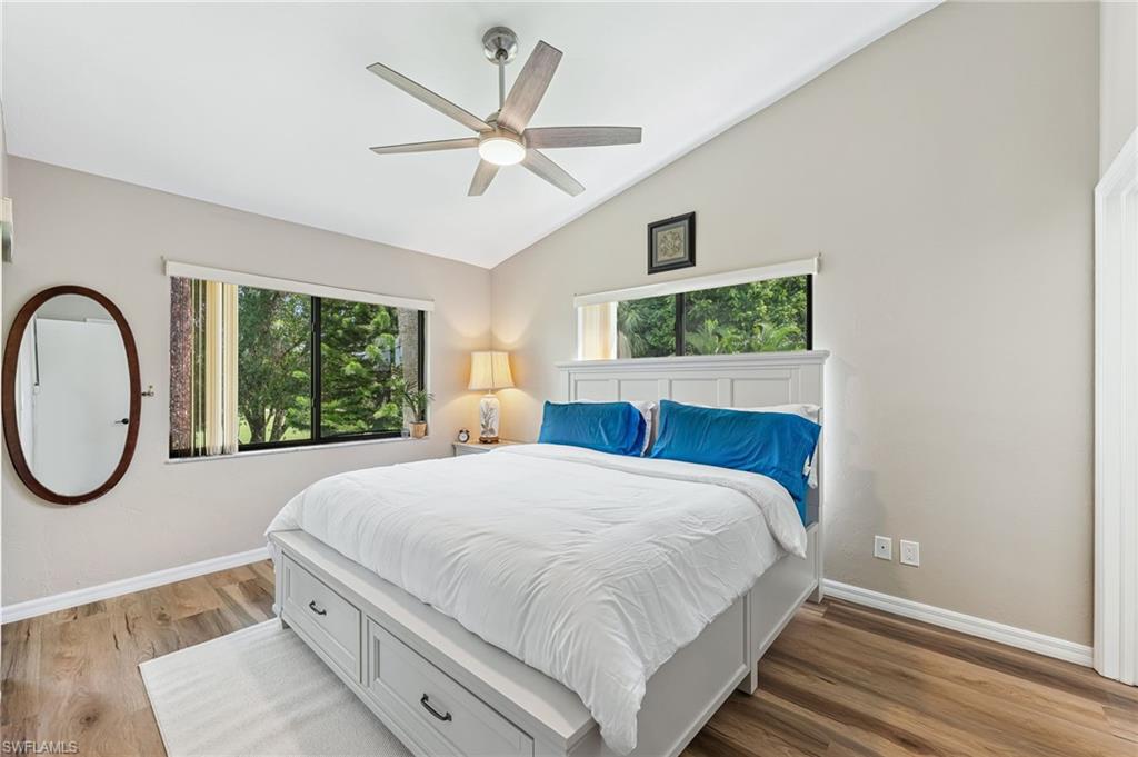 Bedroom featuring vaulted ceiling, wood finished floors, and ceiling fan