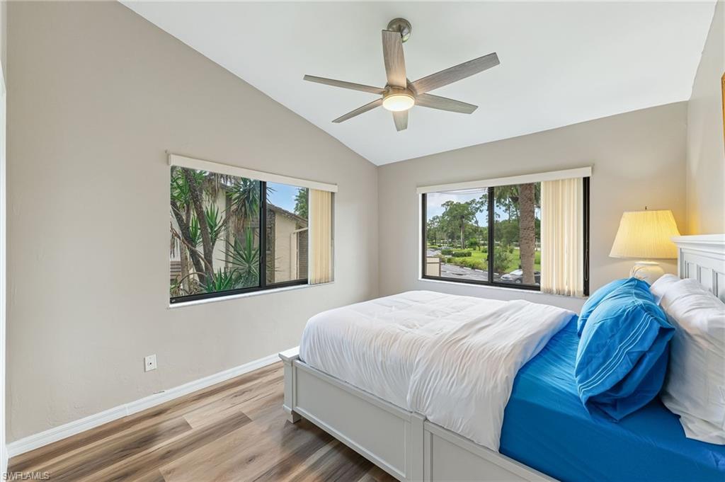 Bedroom featuring wood finished floors, vaulted ceiling, and ceiling fan