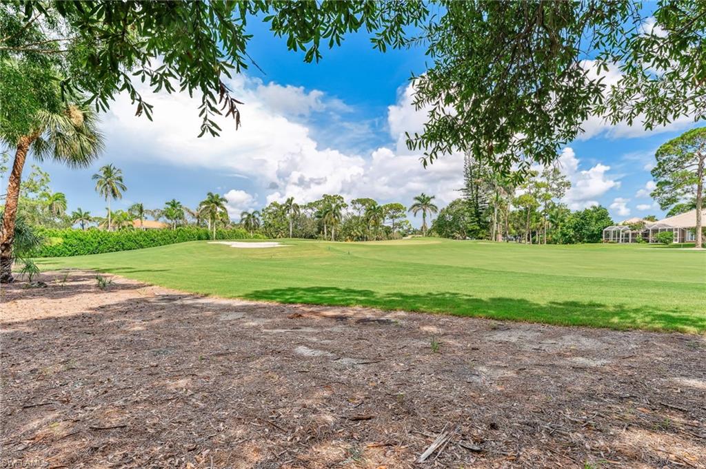 View of property's community with a lawn and view of golf course