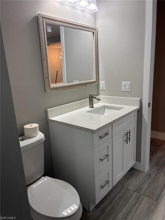 Bathroom featuring vanity, bathtub and toilet.