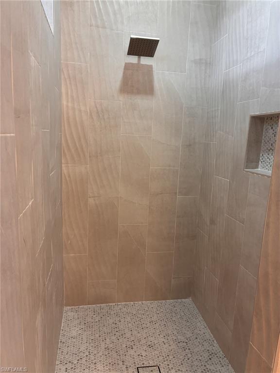 Laundry room featuring light wood-style porcelain floors, hookup for a washing machine, cabinet space, and hookup for an electric dryer