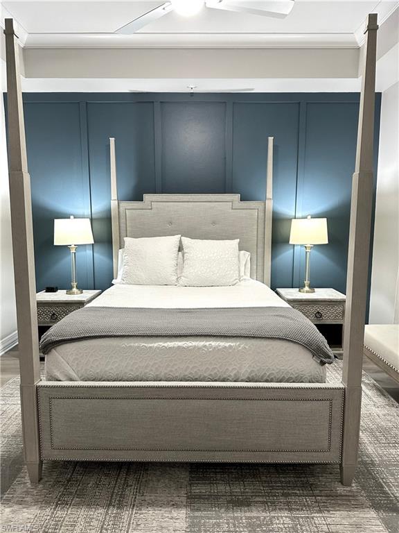 Bedroom featuring a decorative wall and ornamental molding