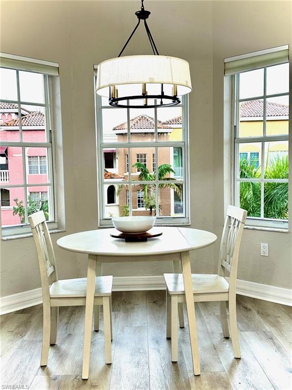Dining area with wood finished floors and baseboards