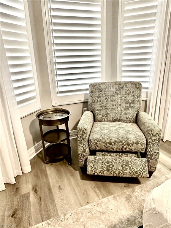 Living area with wood finished floors and baseboards