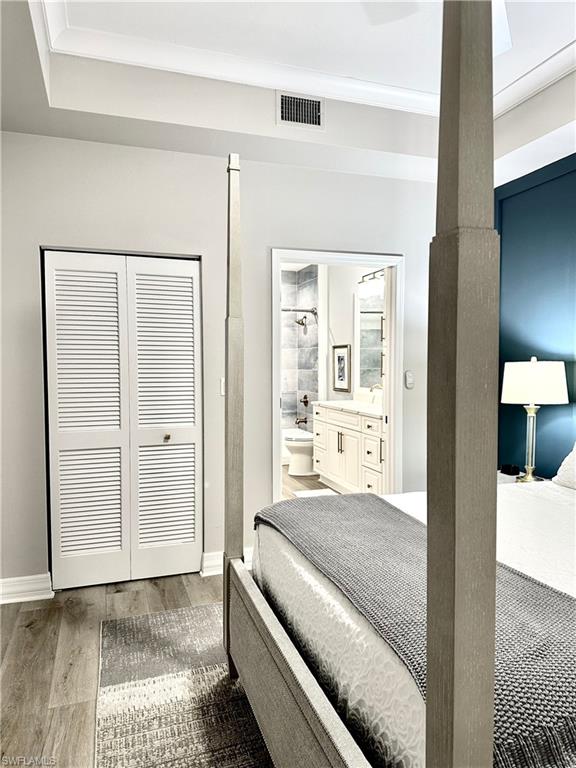 Bedroom with light wood-style flooring and a closet