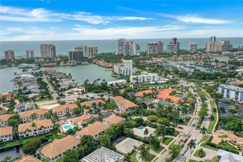 Aerial view of property and surrounding area featuring a large body of water