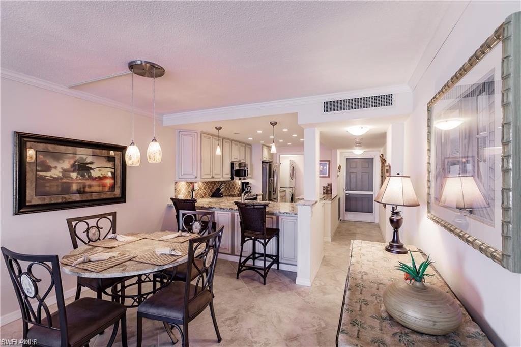 Dining space with ornamental molding and baseboards