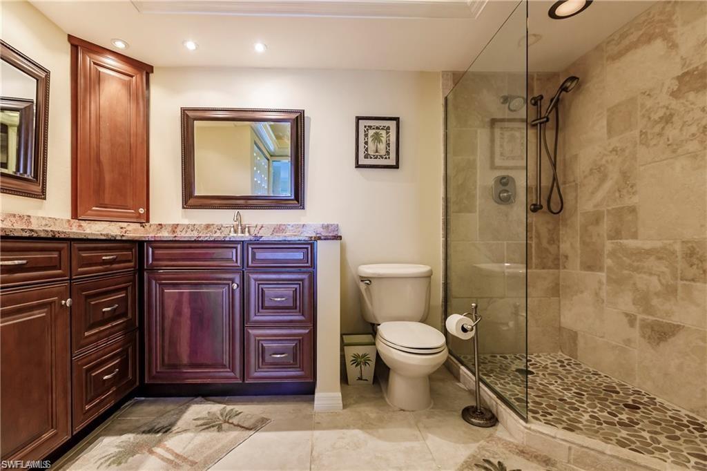 Bathroom with vanity, a walk in shower, recessed lighting, and light tile patterned flooring