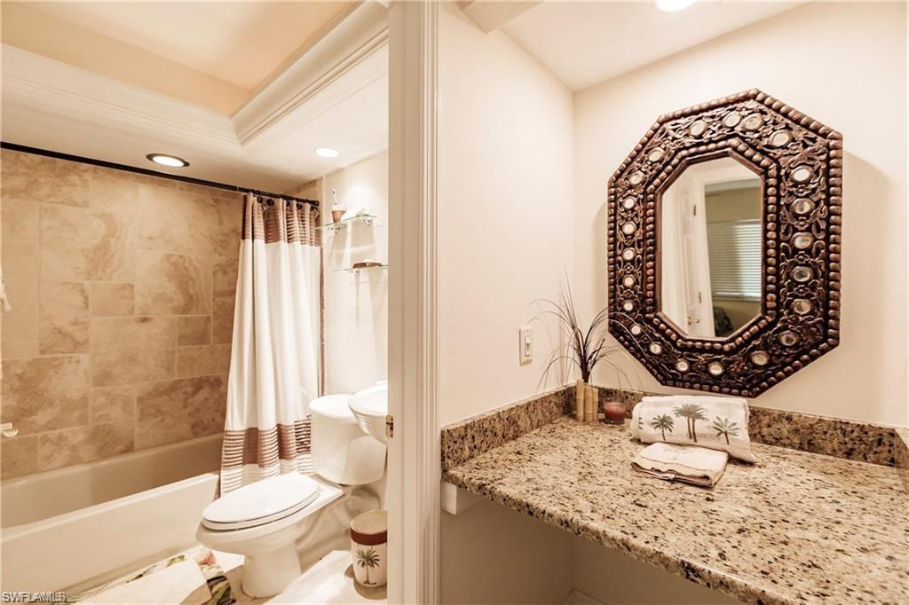 Full bath with recessed lighting, shower / bath combo with shower curtain, and vanity