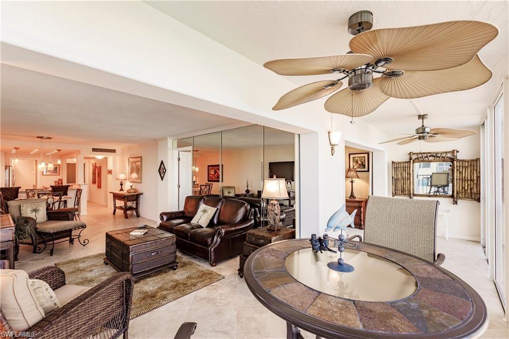 Living area with light tile patterned floors and ceiling fan