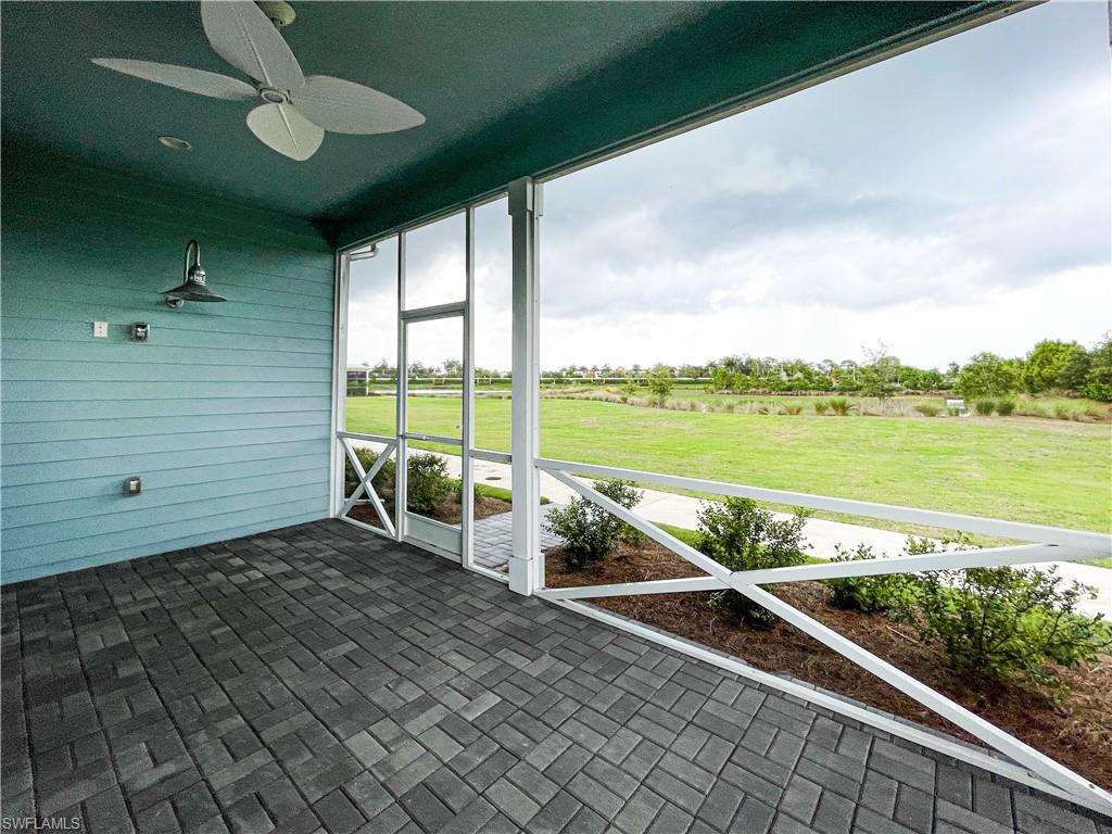 Unfurnished sunroom with ceiling fan