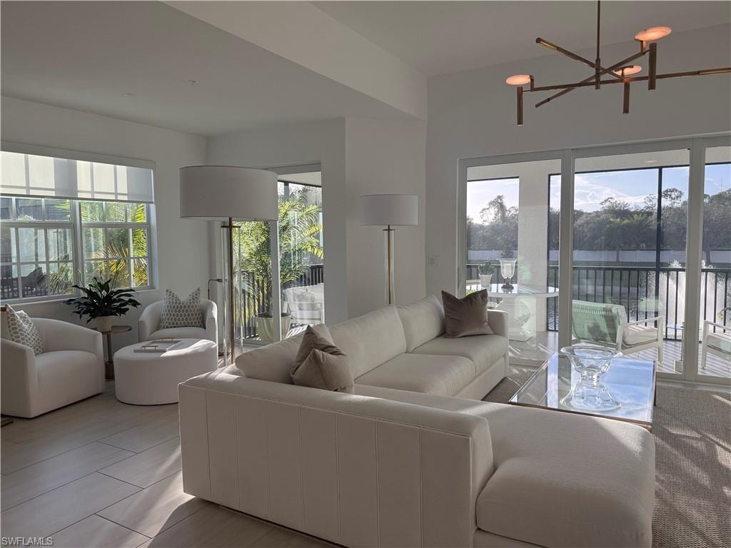 Living area featuring healthy amount of natural light and a chandelier