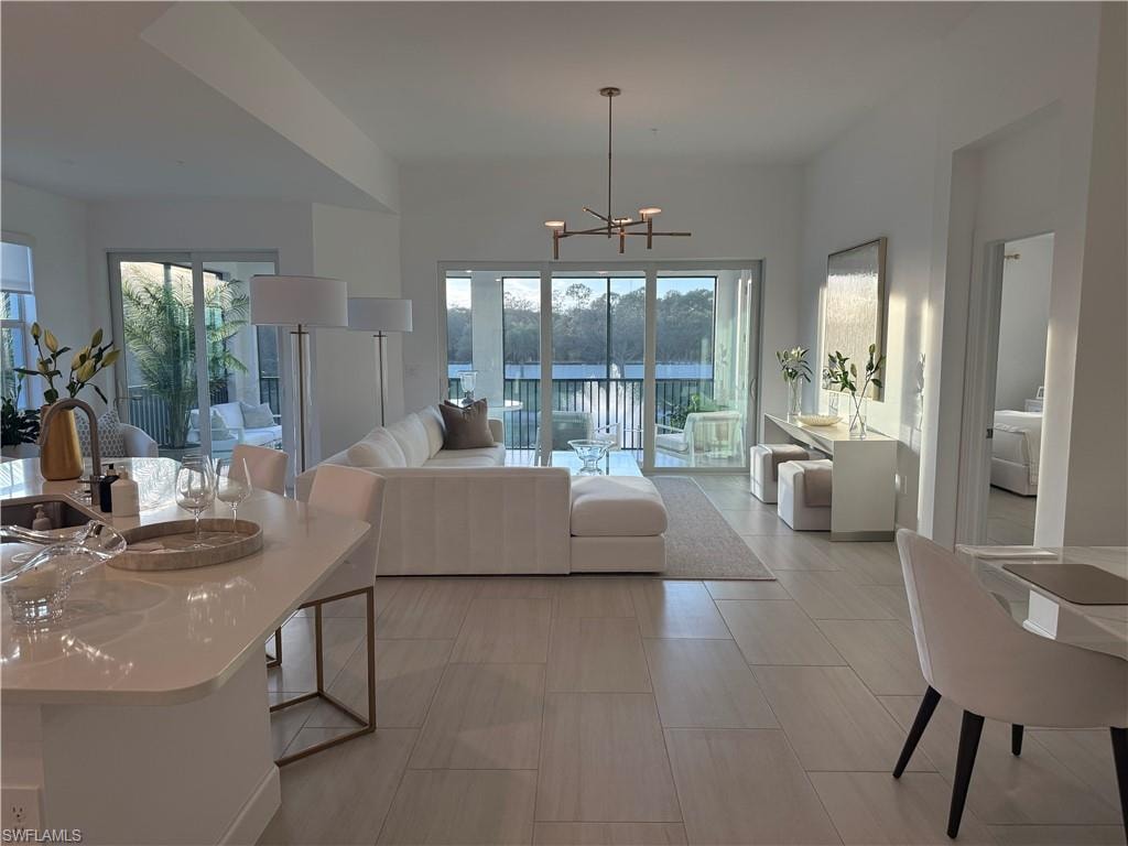 Living room featuring a chandelier and healthy amount of natural light
