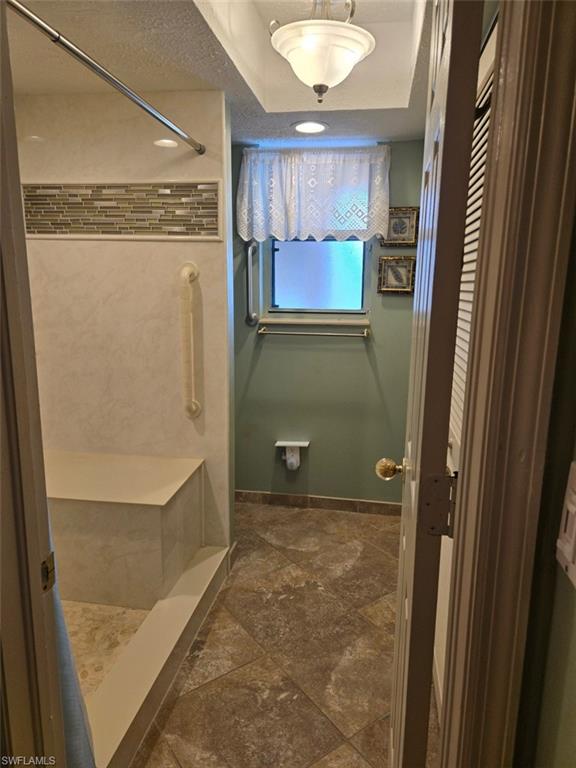 Full bath with a stall shower and a textured ceiling