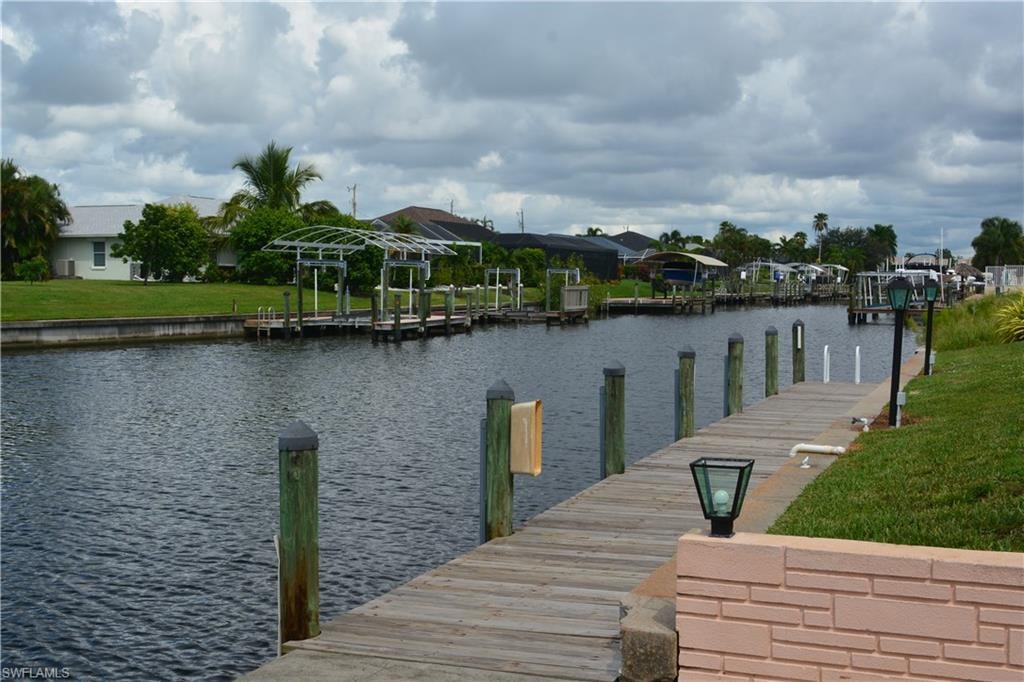 Dock with a water view and a residential view