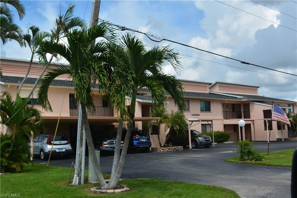 View of building exterior with covered parking