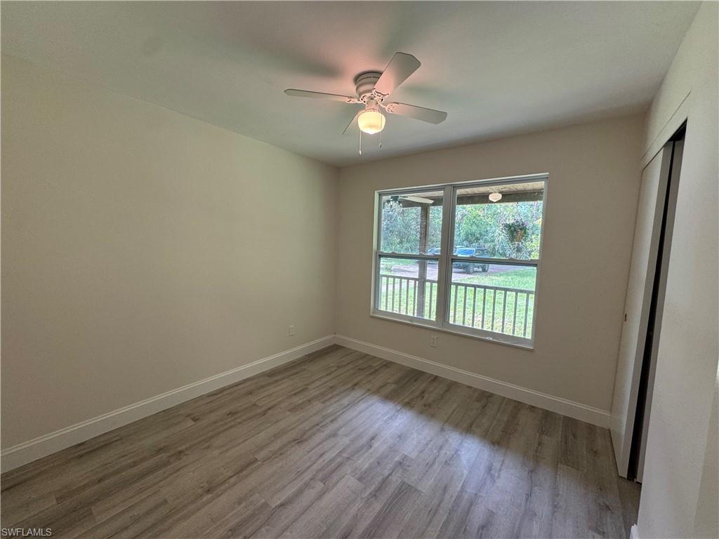 Unfurnished bedroom with light wood-style flooring, a ceiling fan, and a closet