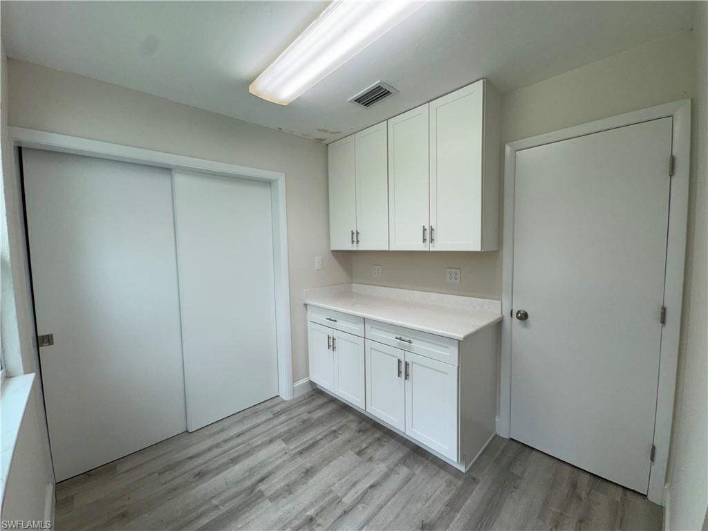 Laundry area featuring light wood-type flooring