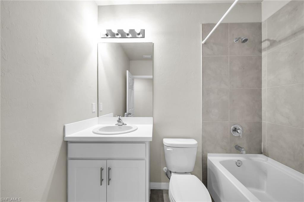 Full bathroom with shower / tub combination and vanity