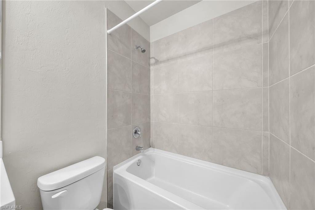 Bathroom with shower / bathtub combination and toilet