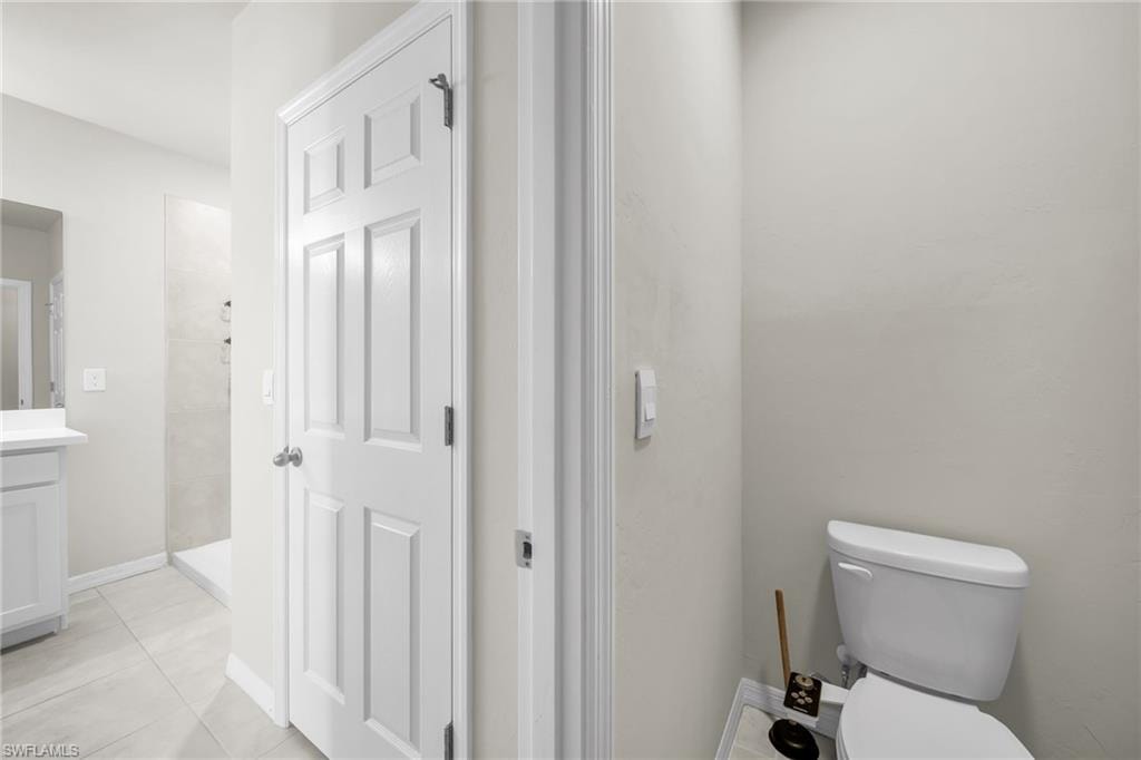 Full bath featuring vanity, a shower stall, and light tile patterned floors