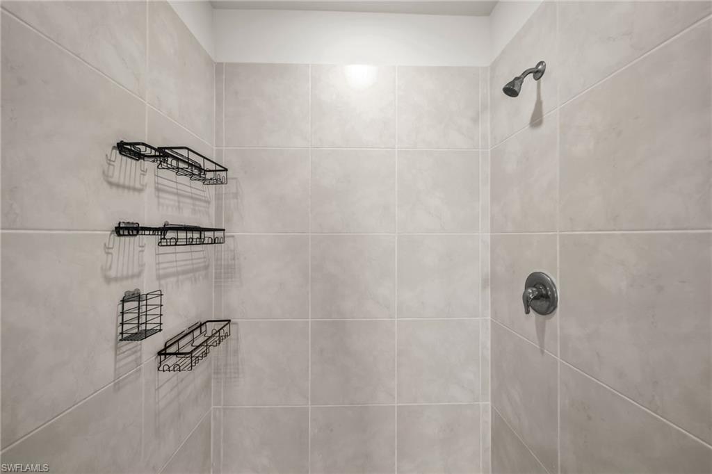 Bathroom view of a tile shower