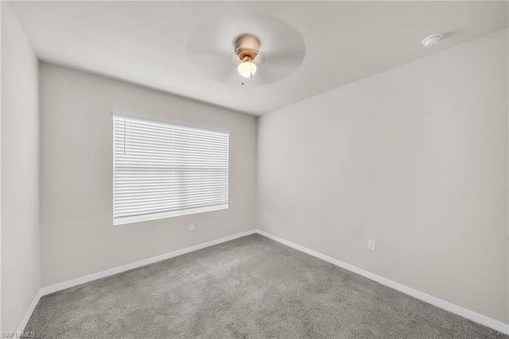 Unfurnished room with carpet and ceiling fan