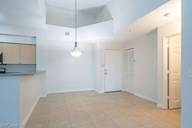 Unfurnished dining area with light tile floors