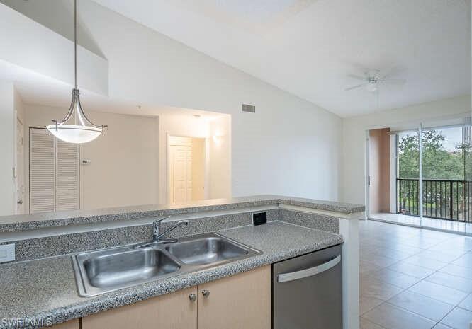 Kitchen with dishwasher, ceiling fan, sink, light tile floors, and lofted ceiling