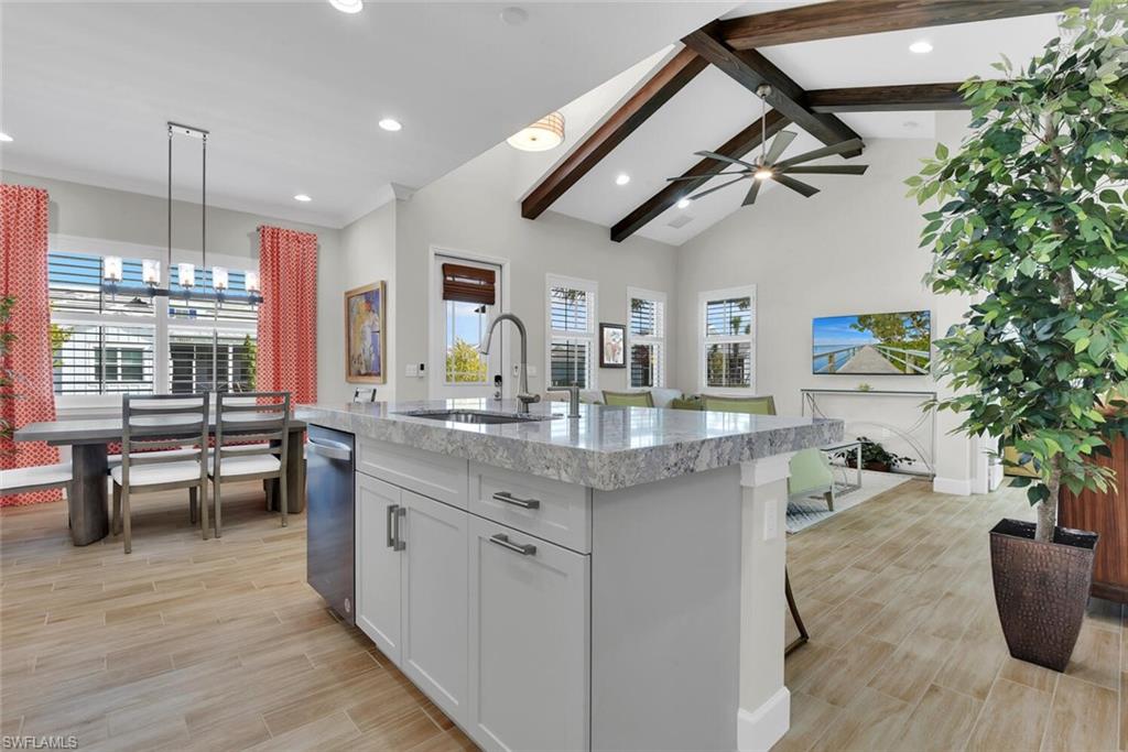 Kitchen featuring an island with sink, a healthy amount of sunlight, ceiling fan, and sink