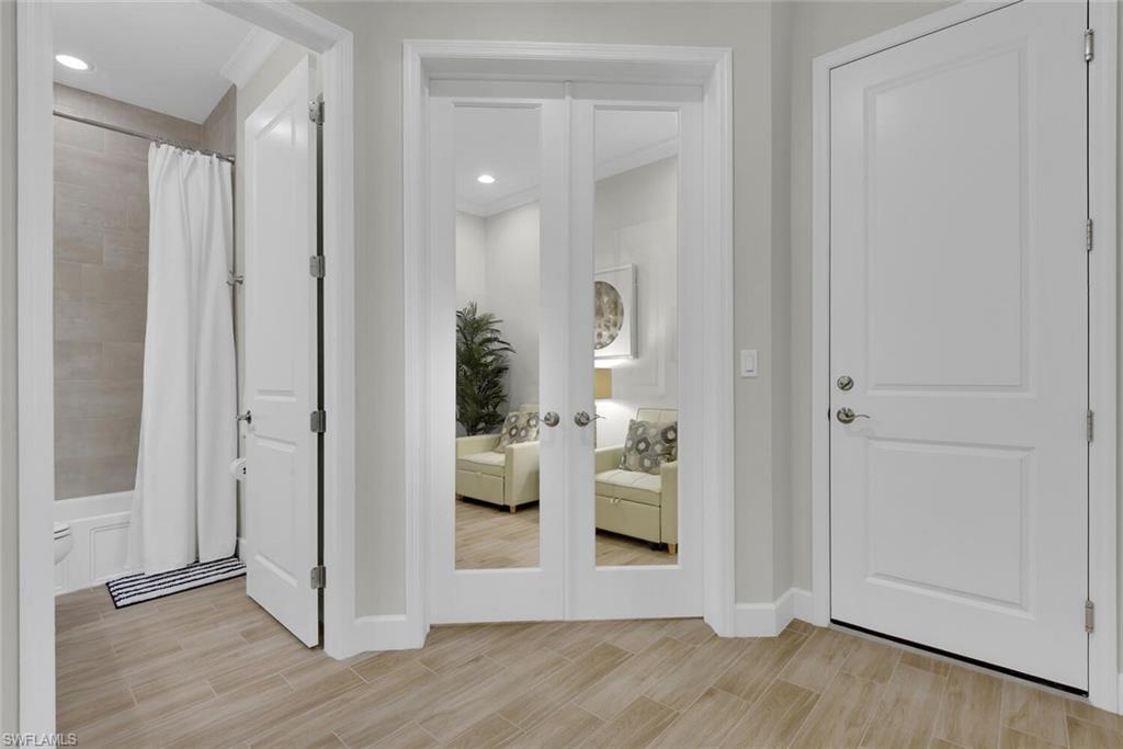 Entrance foyer with french doors and light hardwood / wood-style floors