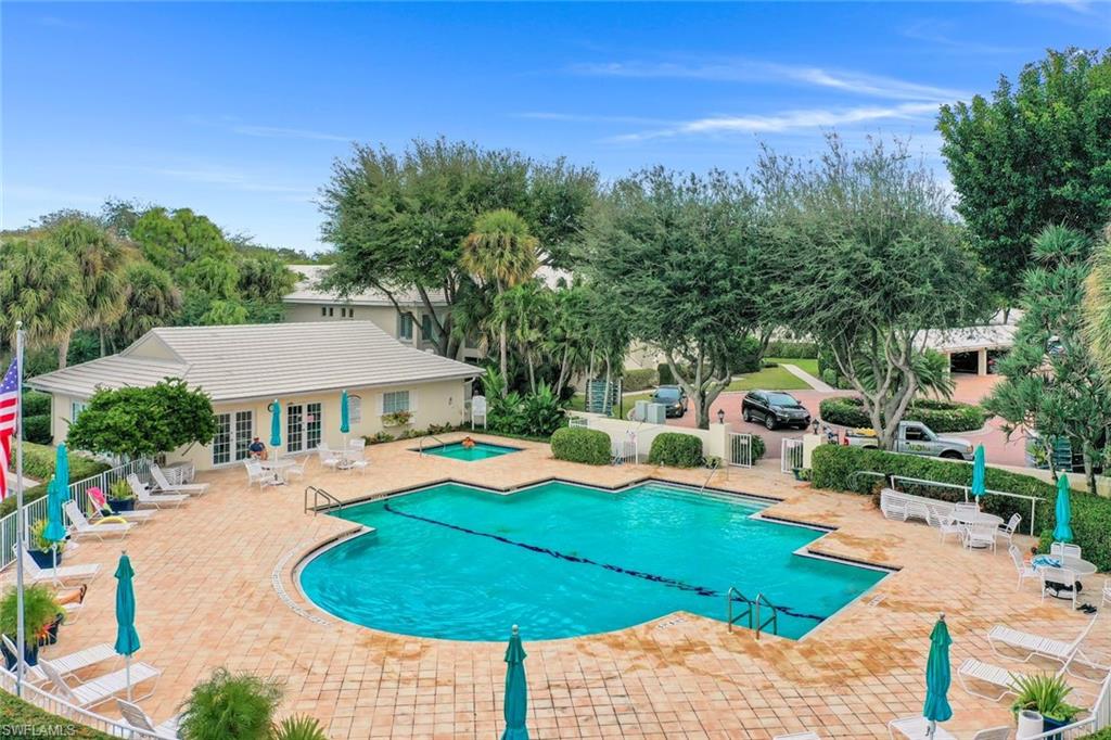 Community pool with a patio area, a hot tub, and french doors