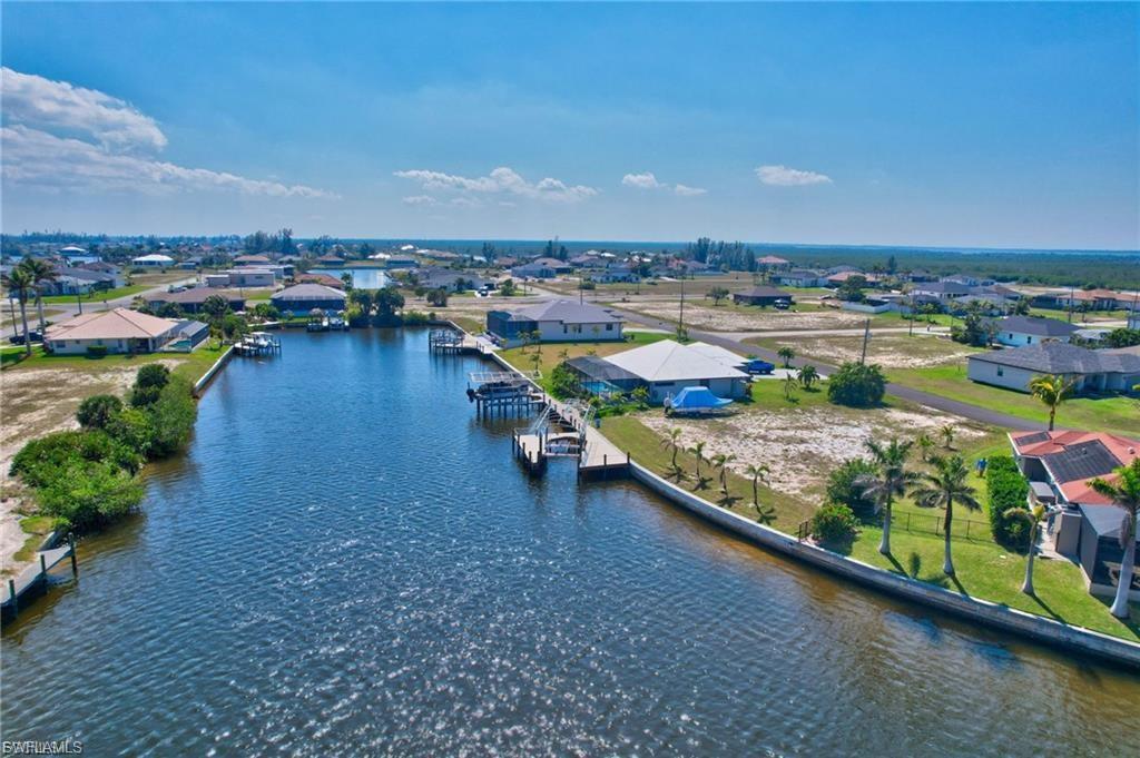 Aerial view of residential area featuring a large body of water