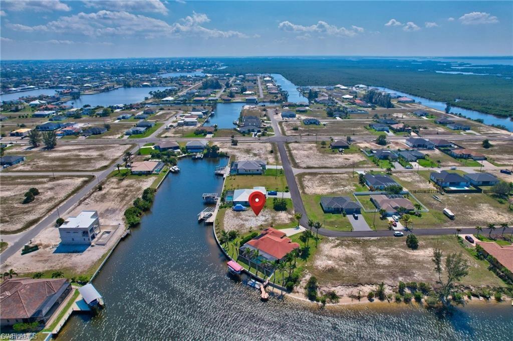 Aerial perspective of suburban area featuring a large body of water