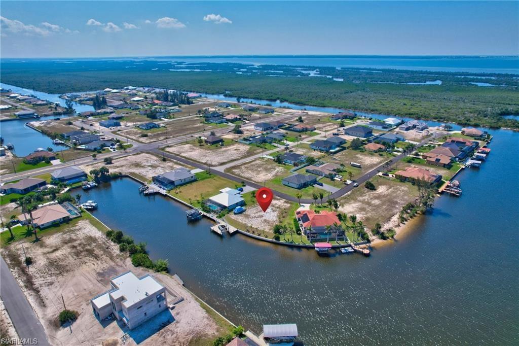 Aerial perspective of suburban area featuring a large body of water