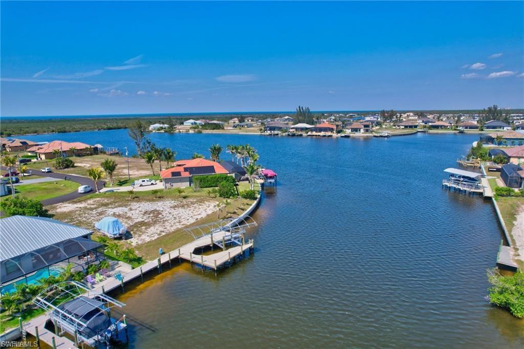 Aerial perspective of suburban area featuring a large body of water
