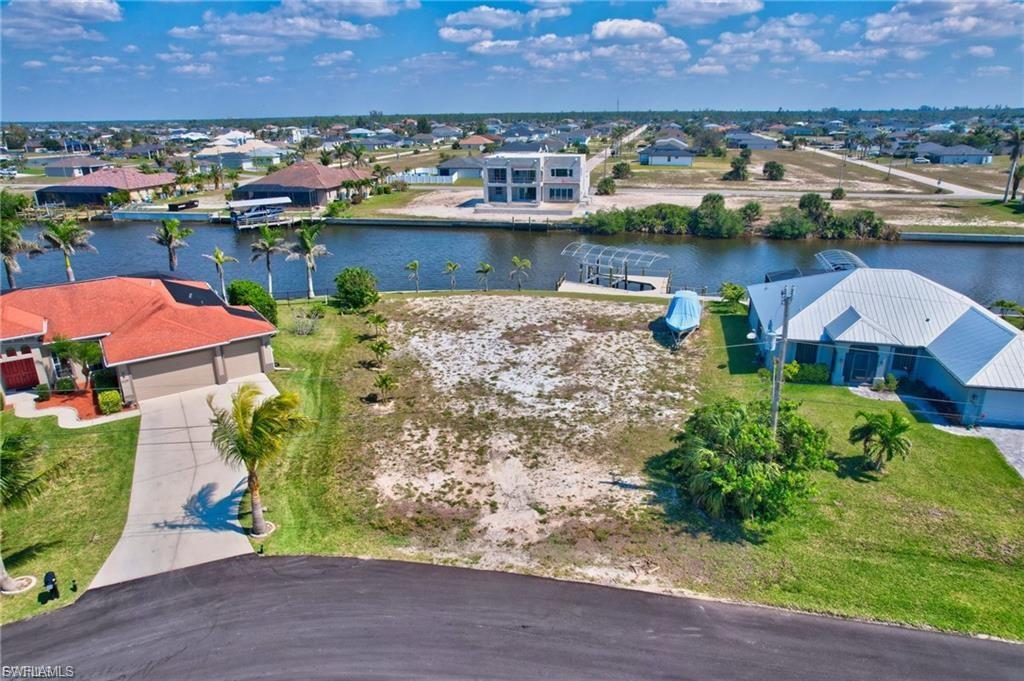 Aerial view of residential area featuring a nearby body of water