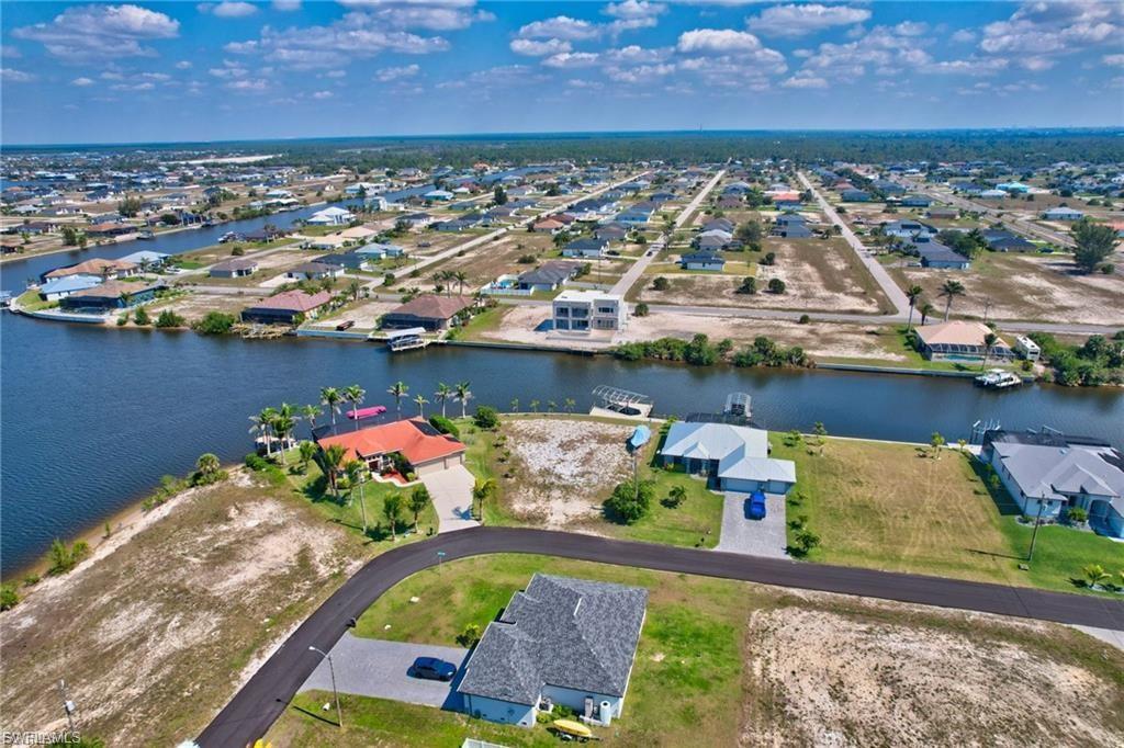 Aerial view of residential area featuring a large body of water