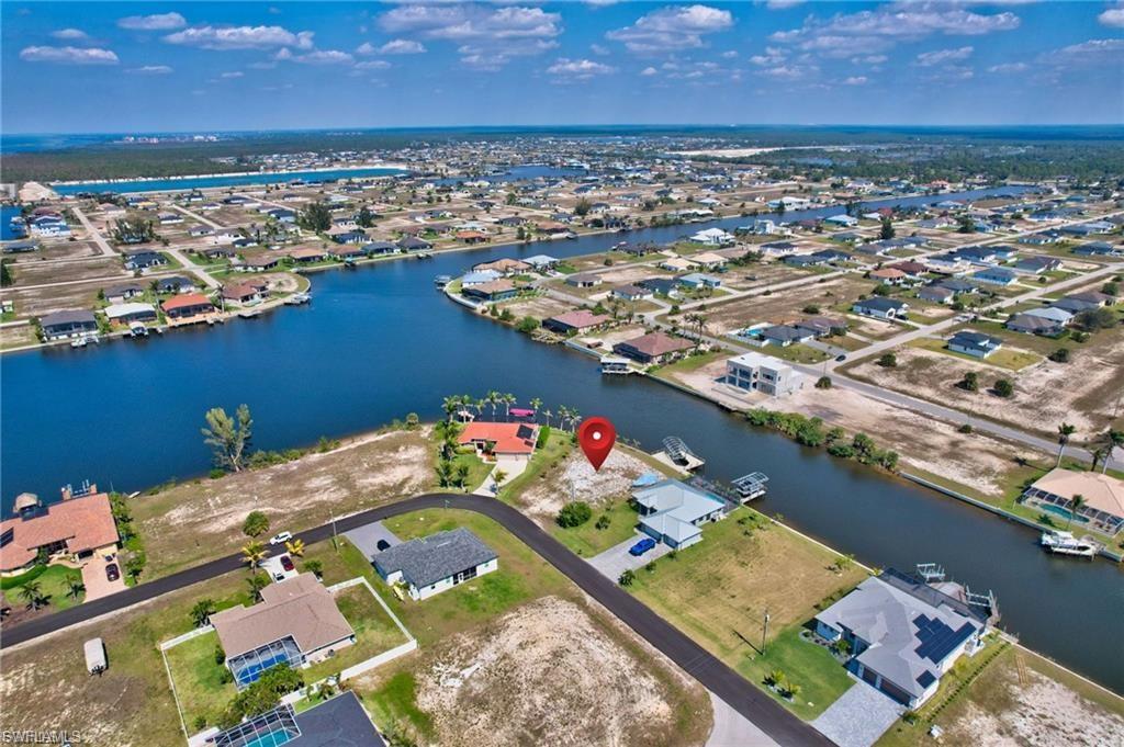 Aerial view of residential area featuring a large body of water