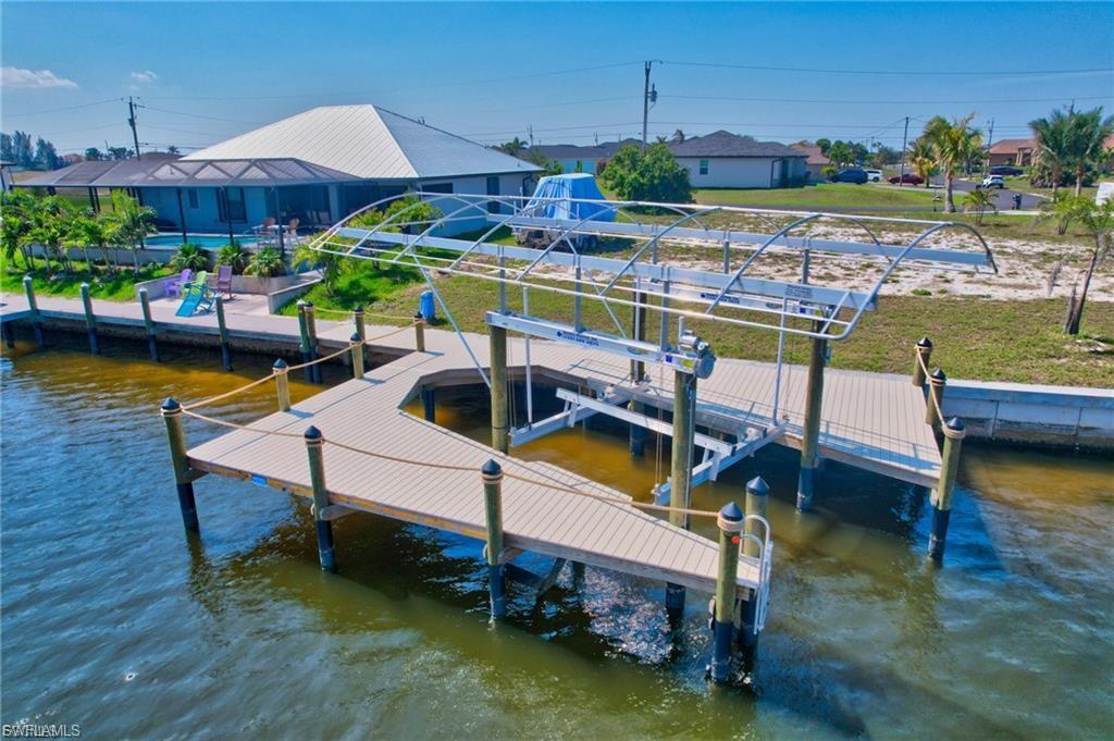 Dock area with boat lift and a water view