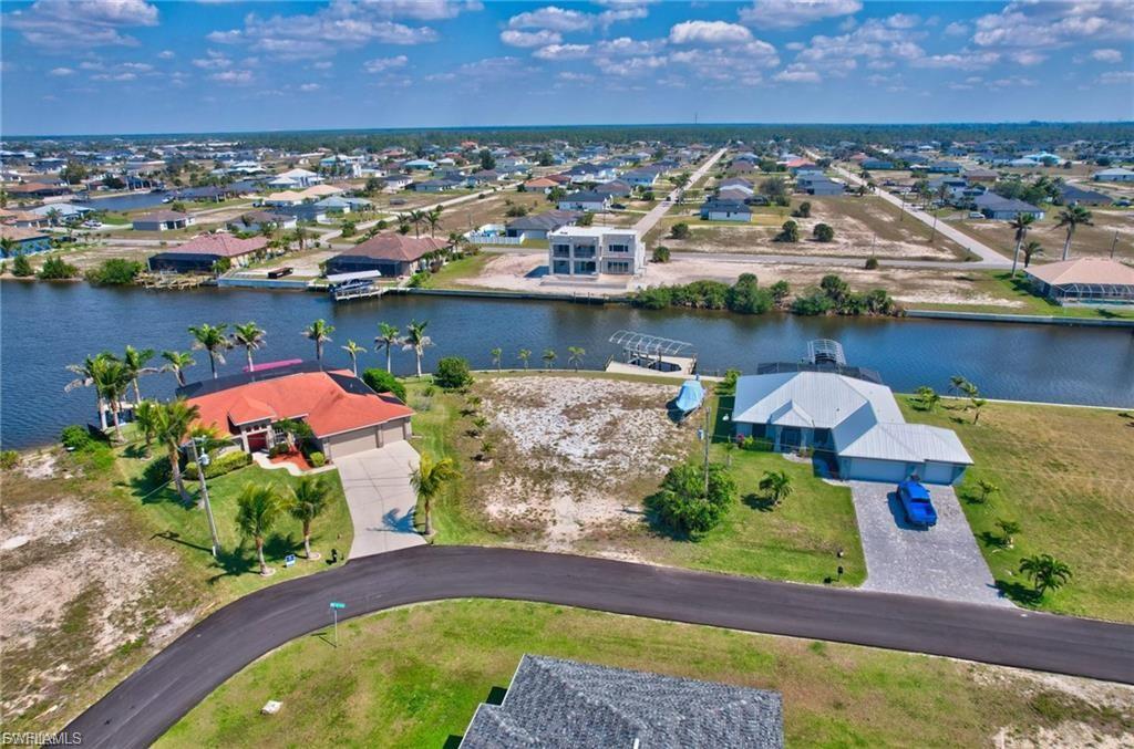 Aerial perspective of suburban area featuring a nearby body of water