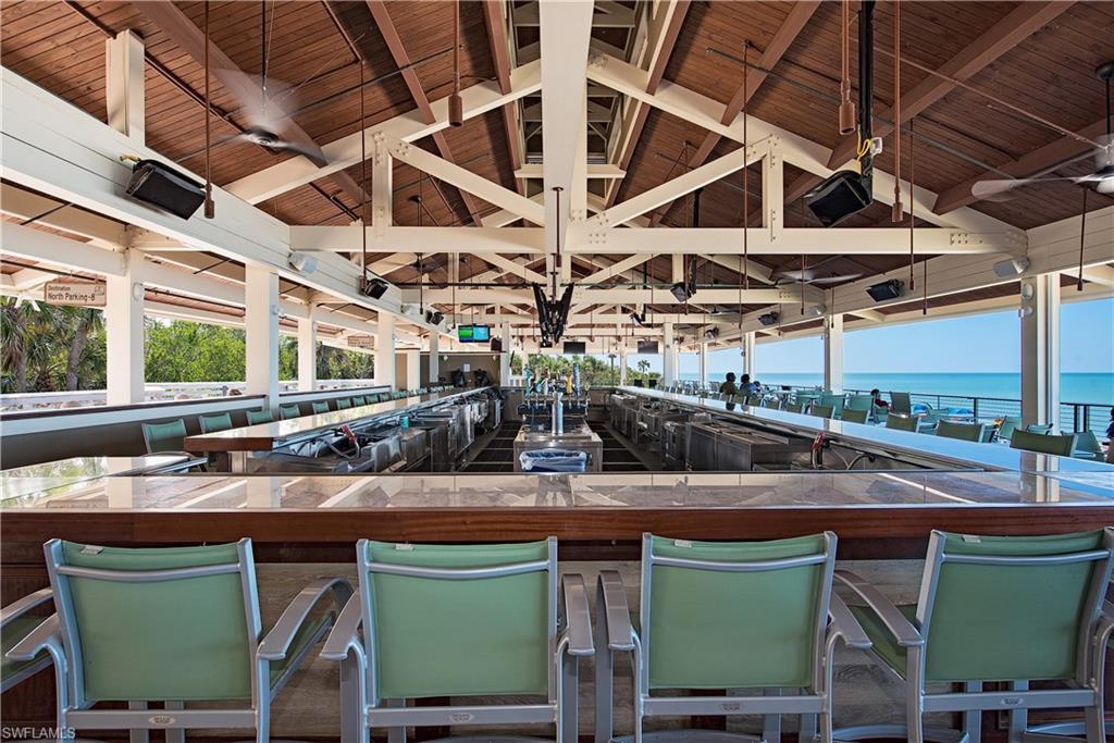 Outdoor dining with view of water and beach
