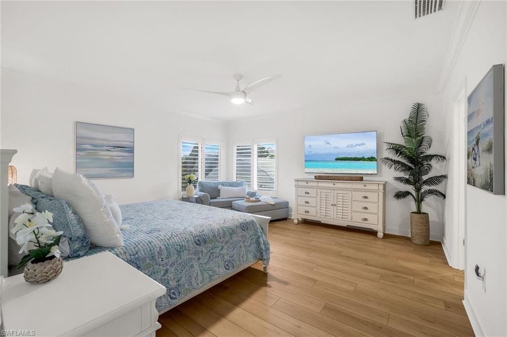 Spacious primary bedroom with sitting area and a TV