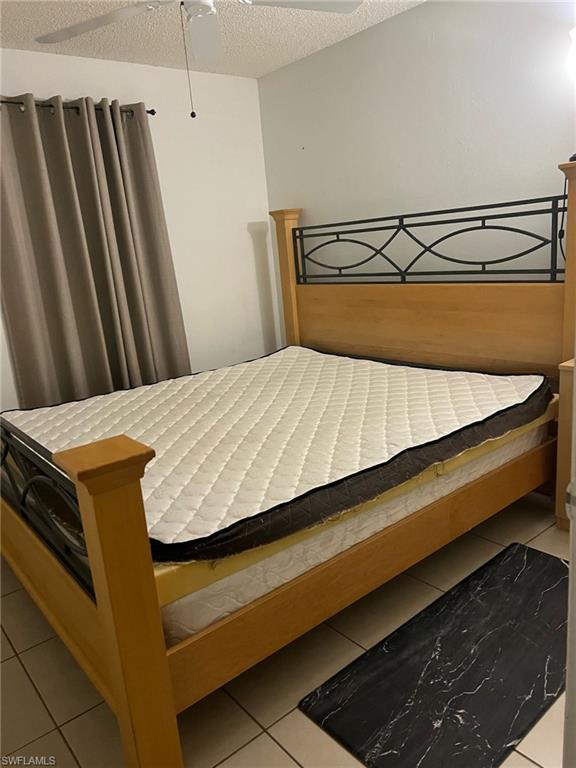 Bedroom with tile patterned floors and a textured ceiling
