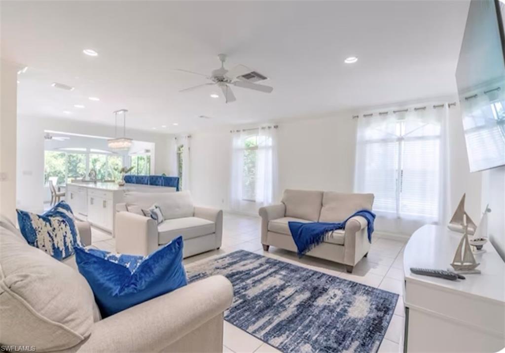 Living room with light tile patterned floors, recessed lighting, and ceiling fan
